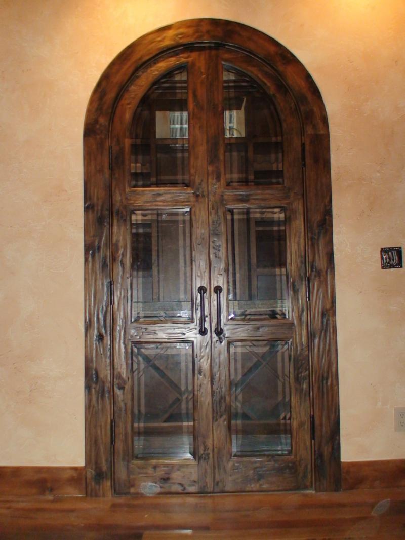 Knotty alder true arch double doors with a hand scraped finish and beveled glass